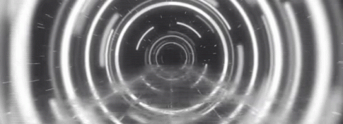 a black and white po of an abstract tunnel with only lights