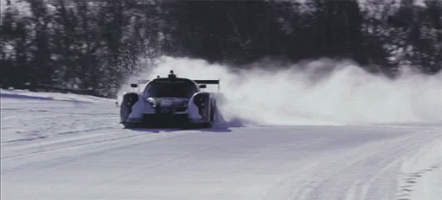 a race car is driving down the snowy road