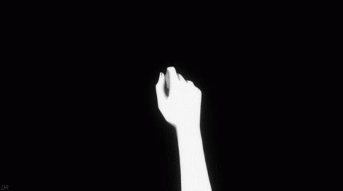 a black background with a silhouette of someone's hand reaching upward