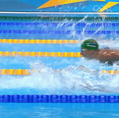 a man swimming in a pool with water