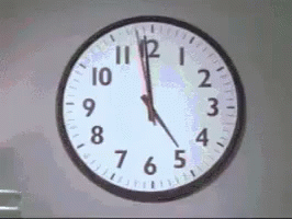 a wall clock showing the time before 2 04