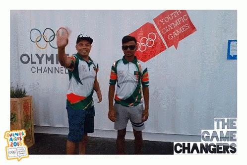 two men are dressed up as olympic figures in front of the games changers wall