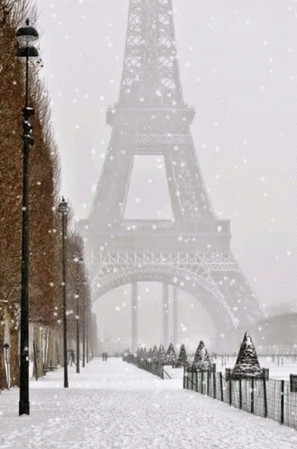 eiffel tower in a snowy day with people walking around