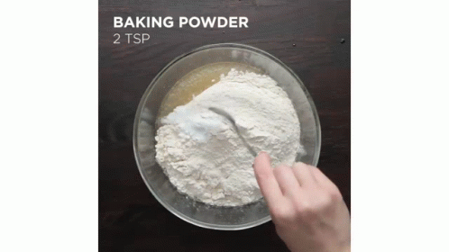 two hands mixing white powder into a bowl