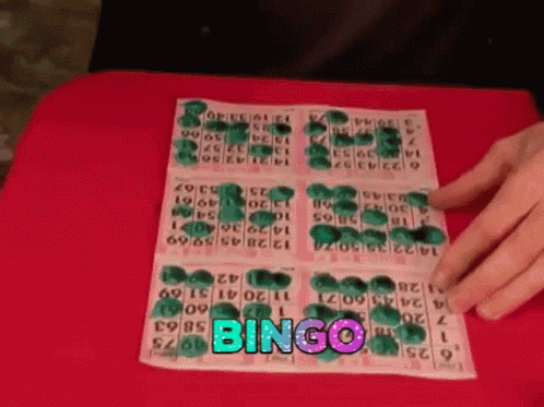 a hand is holding onto a lot of ons that read'bingo '
