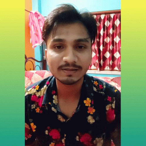 a person wearing floral shirt in bedroom