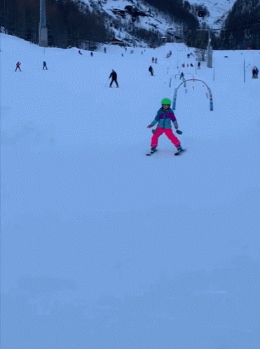 several people on skis are riding down a hill