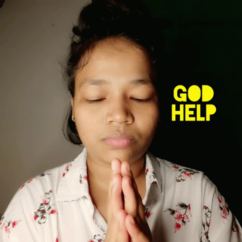 a woman is wearing a flower shirt while holding her hands together to pray