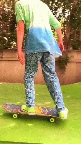 the young person wearing glasses is riding a skateboard