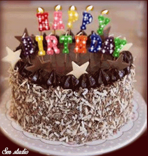 a birthday cake is shown with candles and stars on it
