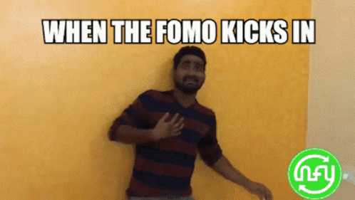 a man in striped shirt leaning on wall with caption stating when the fomo kicks in