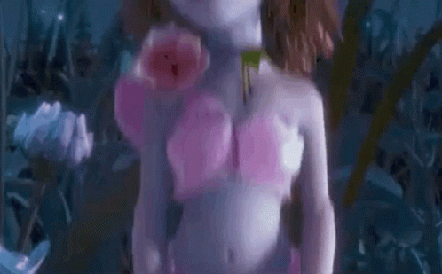 an image of woman without shirt holding flowers