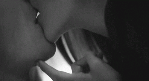 two people that are kissing each other with the faces