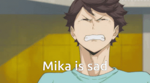 anime character with his head down with the caption mika is sad