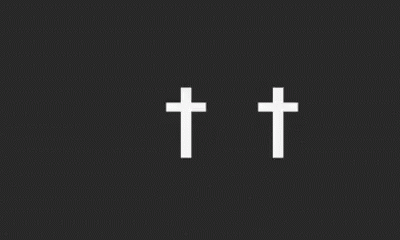a black and white image with three crosses above the center