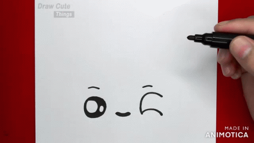 someone is drawing a sad face on a piece of paper