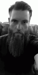 a man with a long beard sitting down