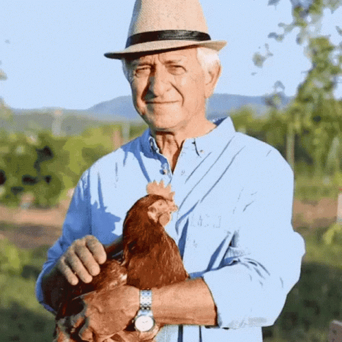 a man in a hat holding a bird