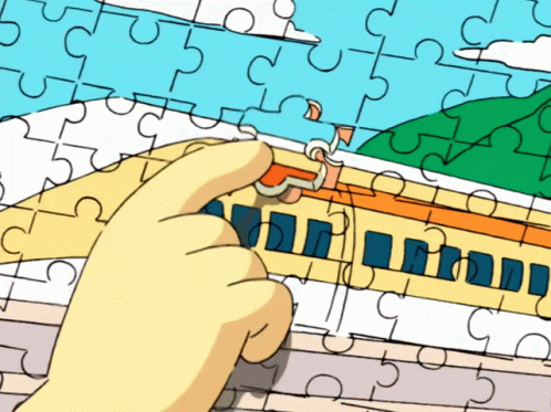 the person is playing with the jigsaw piece puzzle