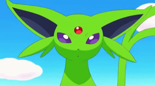 a green pokemon doll with its eyes closed and one eyed up