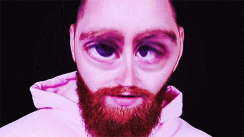 a close up of a man with purple eyes and beard