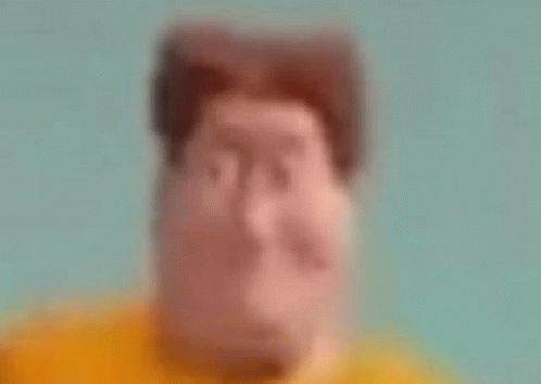 blurry pograph of face in blue shirt looking downward