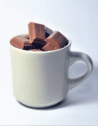 a cup of chocolate bar's in it with milk