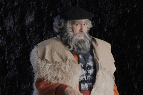 a man with a beard is dressed up in period costumes