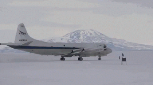 a plane that is on some snowy ground