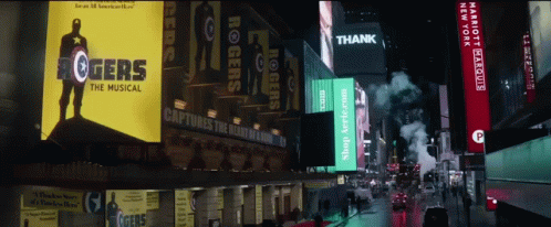 several billboards line the street of a city at night