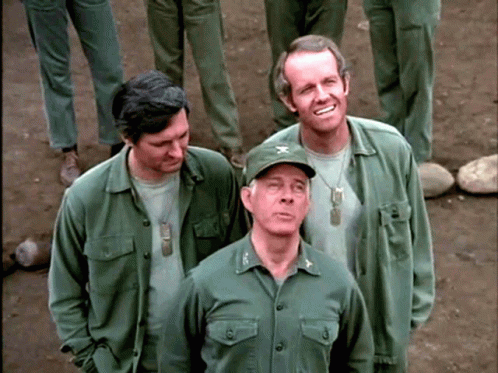 a group of men in army fatigues standing around