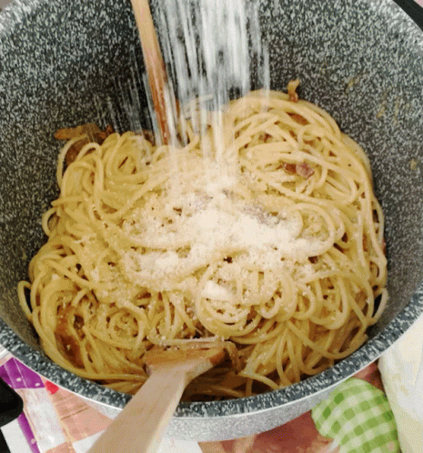 blue noodles are being cooked in a large bowl