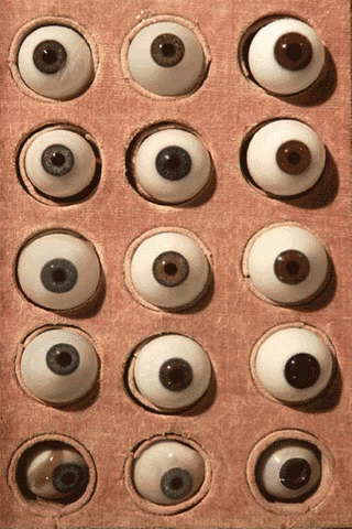 several large, white eyes are in an opened box