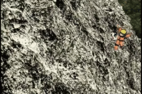 an image of a man climbing up a mountain