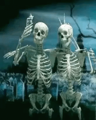 two skeleton skeletons walking on an old street