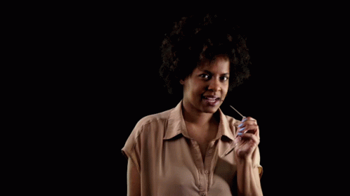 a woman with curly hair holding a toothbrush