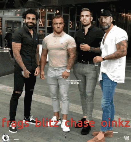 a group of men standing next to each other on a sidewalk