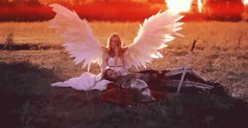 angel siting on the ground with wings spread