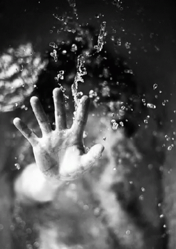 the person is standing under water on their hand