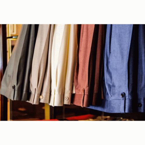 several color shirts hanging on a rack in a shop