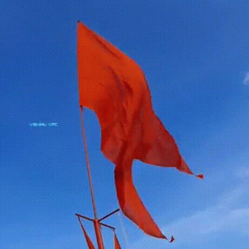 a blue flag flying in the sky on an orange sky background