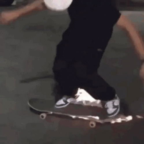 a person in black pants and sneakers on a skateboard
