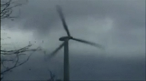 a wind turbine blows through a foggy landscape