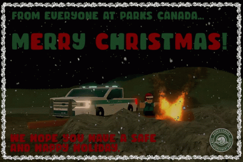 a white christmas truck driving past a fire in a field