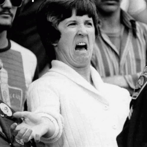 a woman with a surprised expression in front of a group of people
