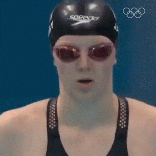 a man in swimming goggles and sunglasses with swimming cap