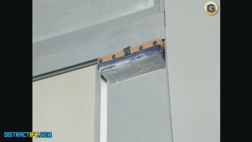 an image of a blue rail coming through an opening in a wall