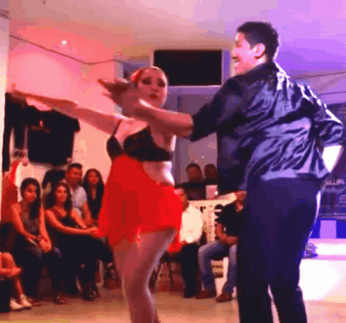 a man and a woman dancing on stage during a dance