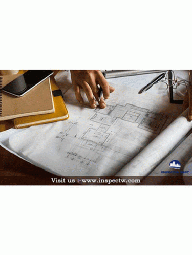 a blueprint is on a table that has papers, pens and markers