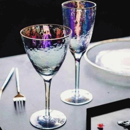 an image of two wine glasses on a table